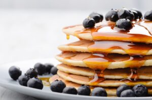 Bananen-Pfannkuchen mit Blaubeeren und Ahornsirup