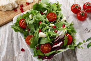 Salat mit Tomaten, Parmezzano, Rucola und Granatapfel